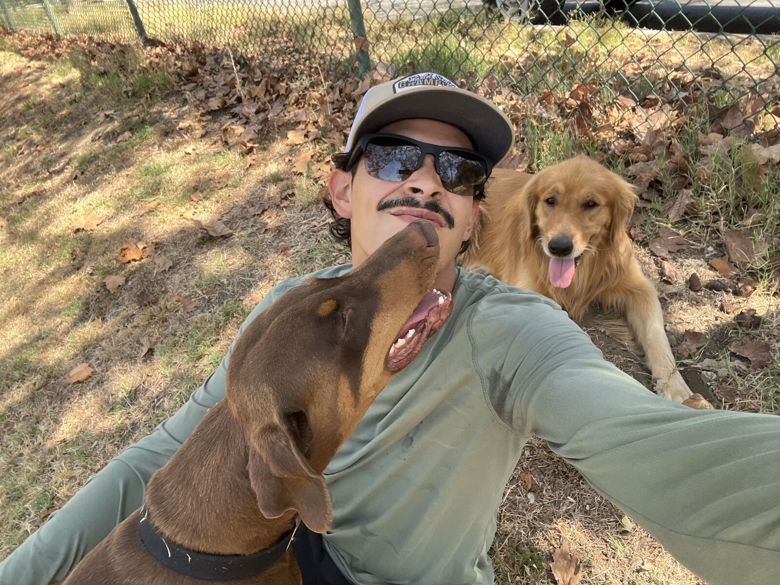 Tony, owner of National Carpet Cleaning, outdoors with two dogs