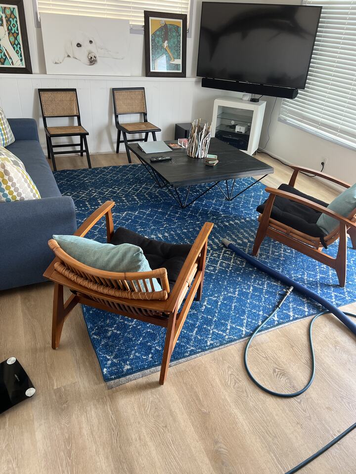 Blue area rug with upholstered seating in a lounge