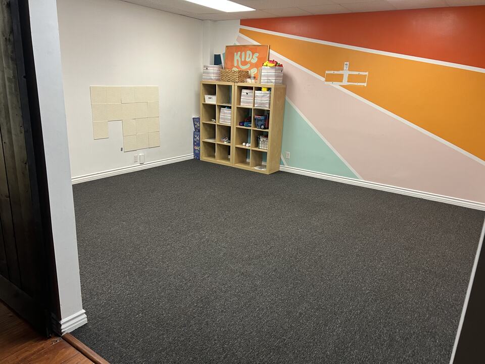 Carpet in a colorful activity room with cubby shelving