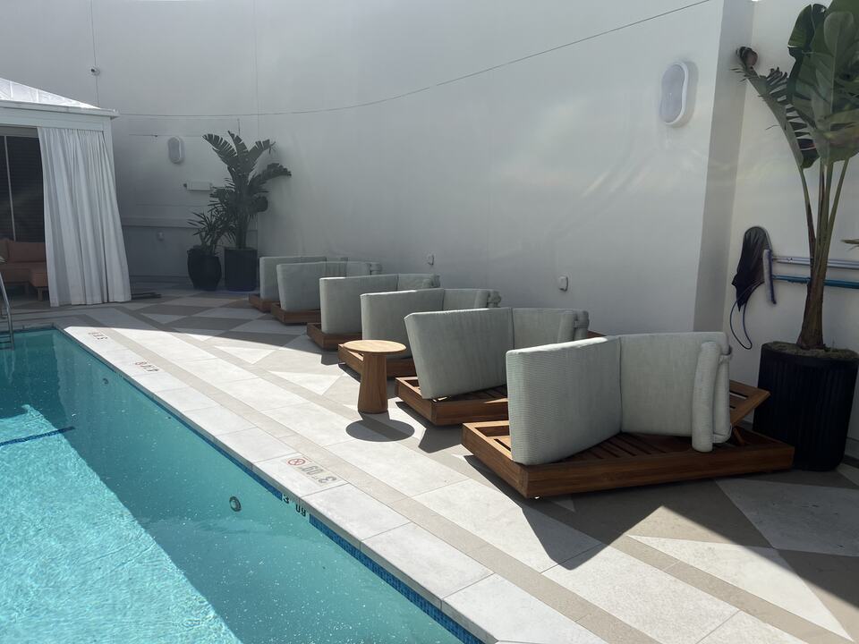 Outdoor upholstered chairs beside a swimming pool