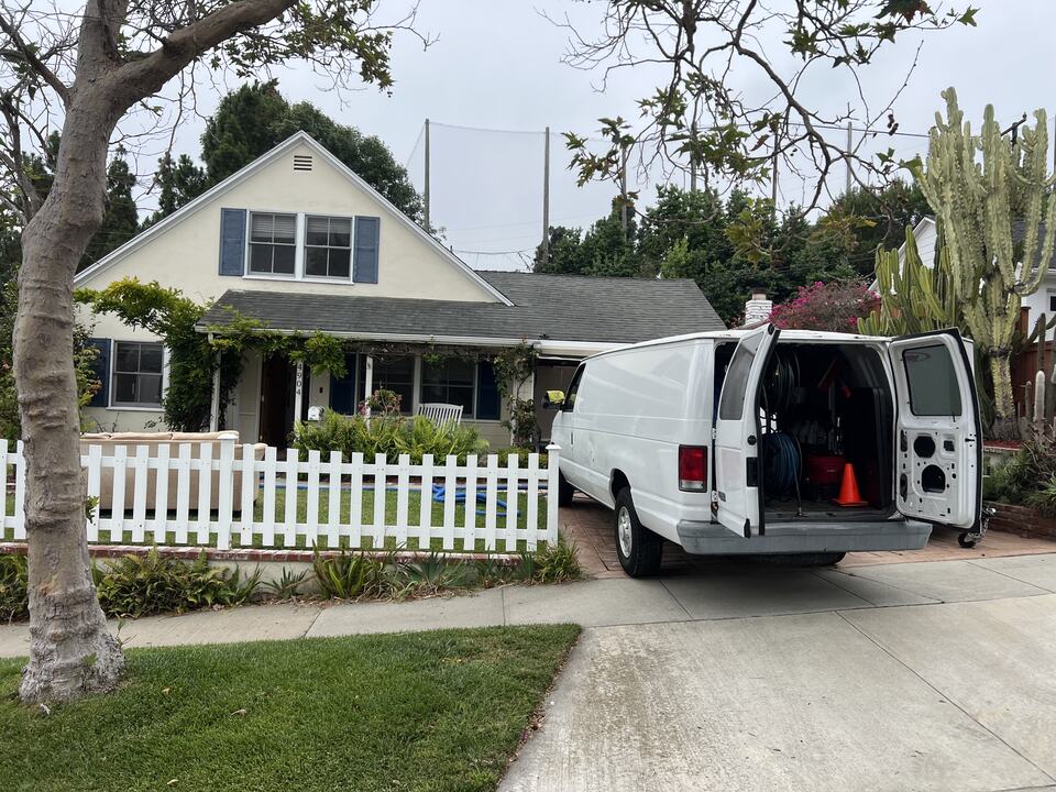 Open service van in a residential driveway