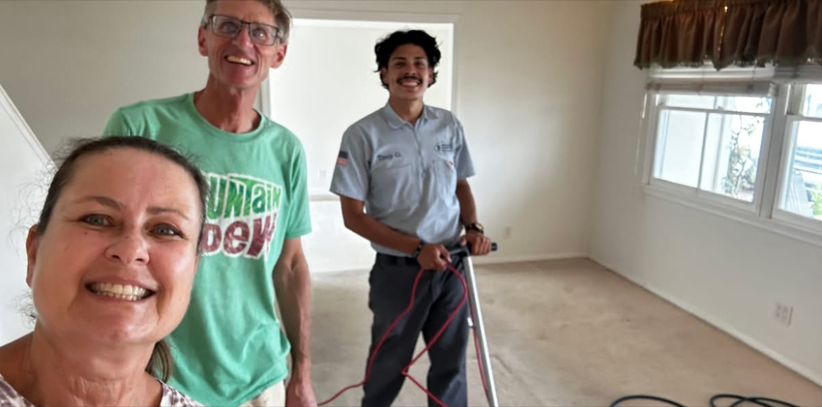 The owner of National Carpet Cleaning with two customers after a carpet-cleaning visit